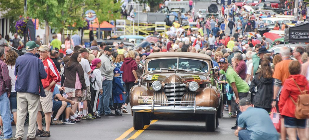 A 1941 Cadillac pulls through the crowd in Fairport, NY